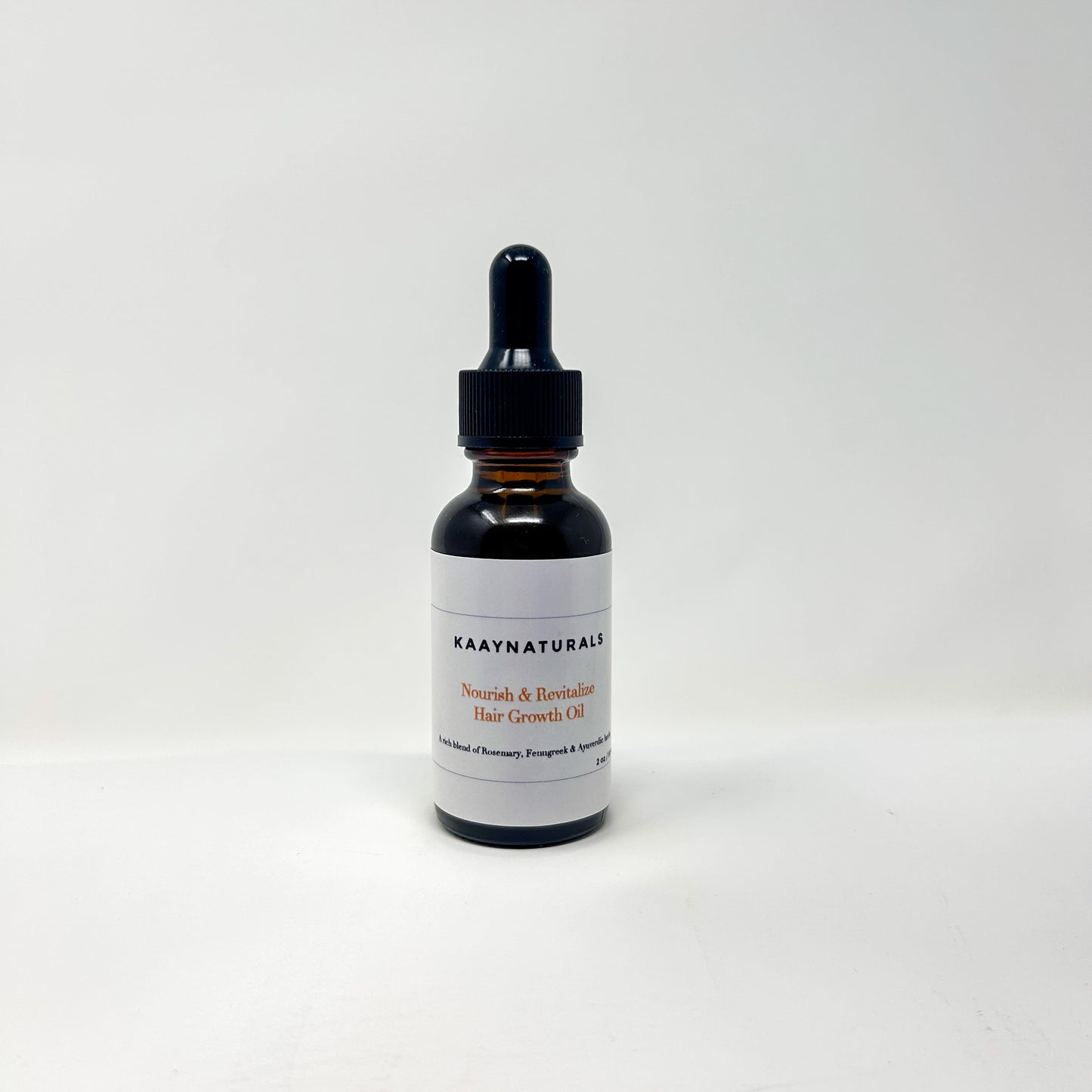Black dropper bottle with a white label on a light gray background