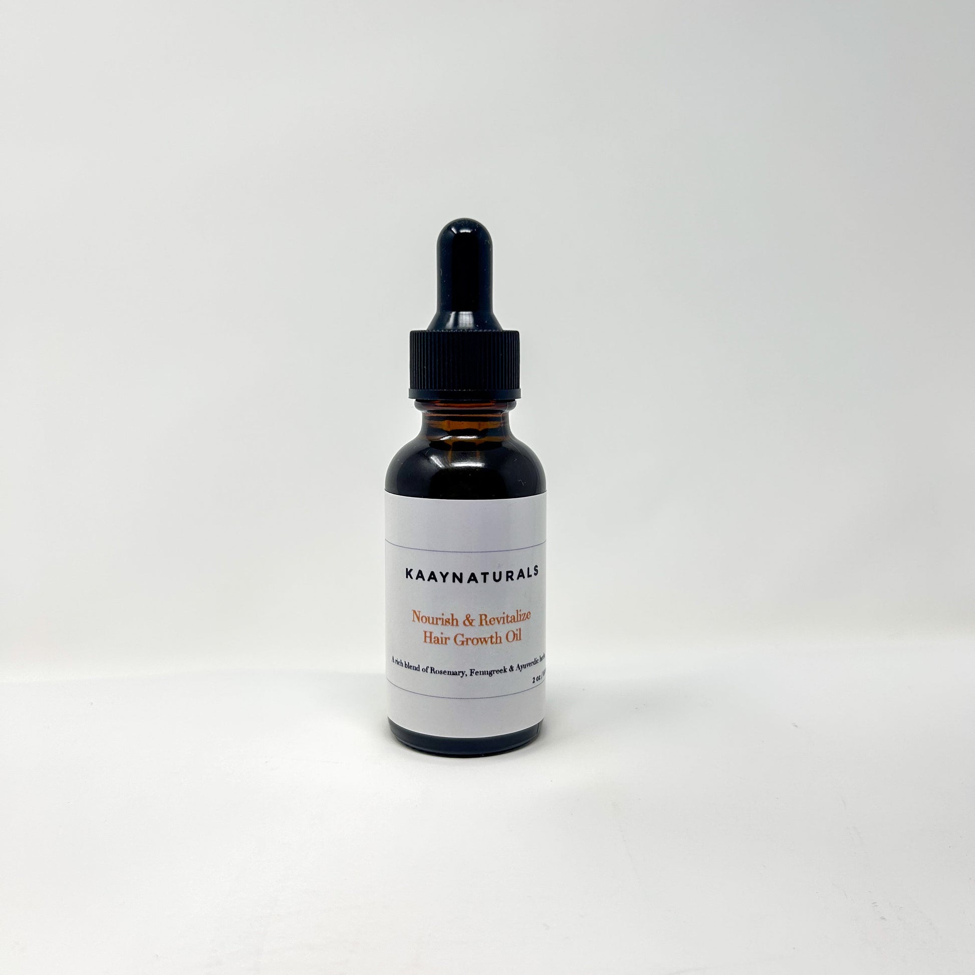 Black dropper bottle with a white label on a light gray background