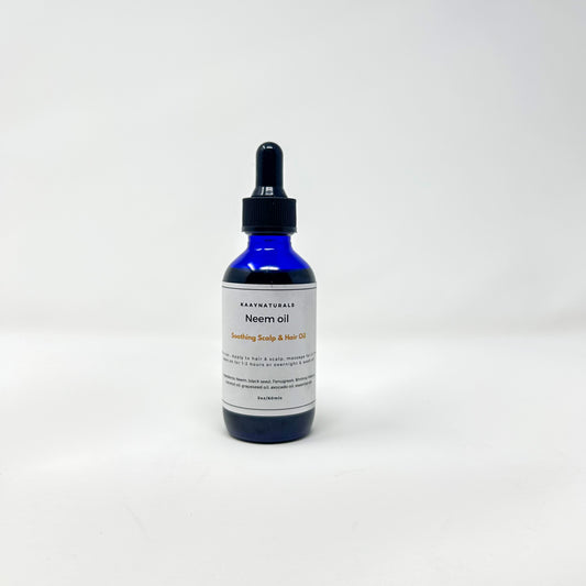 Bottle of neem oil with a dropper on a white background